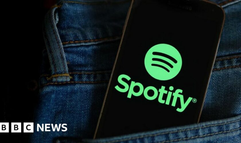 Spotify logo on a phone in a pocket