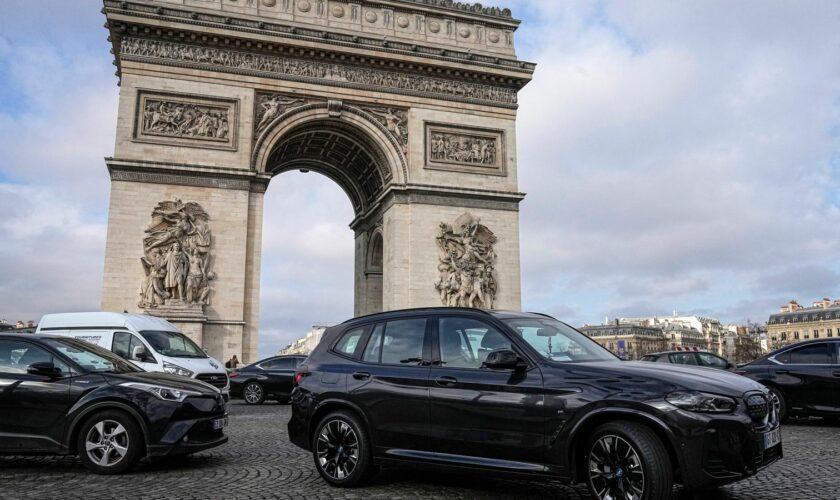 FILE - SUV car drive on the Champs Elysees avenue, near to the Arc de Triomphe Wednesday, Jan. 31, 2024 in Paris. Paris residents are voting on Sunday, Feb. 4, 2024 whether to muscle SUVs off the French capital...s streets by making them much more expensive to park. It's the latest leg in a drive by Socialist Mayor Anne Hidalgo to make the host city for this year...s Olympic Games greener and friendlier for pedestrians and cyclists. (AP Photo/Michel Euler, File)