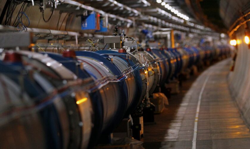 The LHC (Large Hadron Collider) tunnel is pictured during a visit at the Organization for Nuclear Research (CERN) in Meyrin, near Geneva April 10, 2013. As hundreds of engineers and workers start two years of work to fit out the giant LHC particle collider to reach deep into unknown realms of nature, CERN physicists look to the vast machine to unveil by the end of the decade the nature of the mysterious dark matter that makes up a quarter of the universe and perhaps find new dimensions of space.