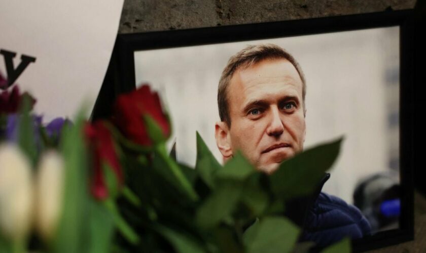 Des photos et des fleurs sont déposées en hommage à Alexeï Navalny devant l'ambassade russe au Royaume-Uni, le 16 février 2024 à Londres