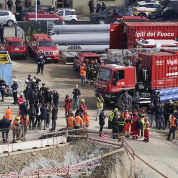 Rescue workers arrive at the scene of an accident at a construction site in Florence, Italy, Friday Feb. 16, 2024. An accident at a supermarket construction site in the Italian city of Florence on Friday killed at least one worker and left four others missing, officials said. (Marco Bucco/LaPresse via AP)