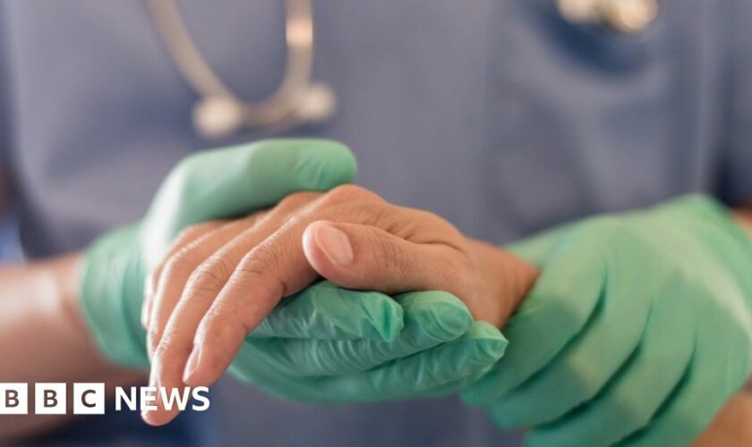 Anaesthetist or anaesthesiologist holding patient's hand