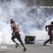 Protestors run from teargas during clashes with police in Dakar on February 9, 2024.