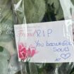 Flowers left at funeral home raided by police as families wait for answers