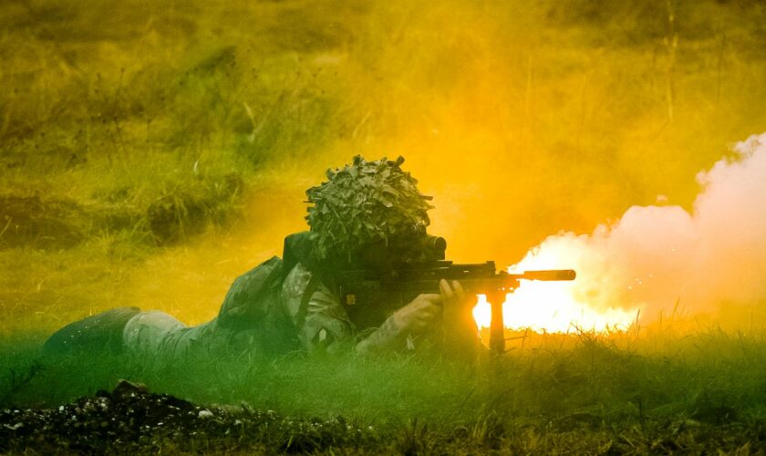 British Army soldiers crawl and fight through smoke and flares as they attack and move forward supported by armour during a Combined Arms Manouevre Demonstration on Salisbury Plain, Wiltshire. PRESS ASSOCIATION Photo. Picture date: Wednesday October, 21, 2015. Photo credit should read: Ben Birchall/PA Wire