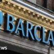 Pedestrians walk past a branch of Barclays bank in central London