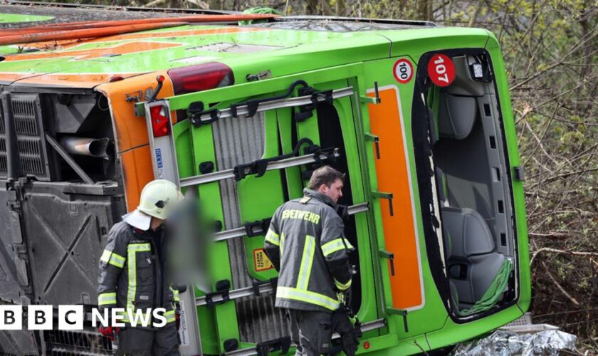 A coach lies overturned on its side at the scene of an accident on the A9 near Leipzig, Germany