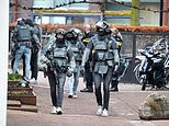 Netherlands hostage incident: Three sobbing hostages are released from Ede cafe where man is threatening to blow himself up with people still inside as 150 homes are evacuated and town centre closed down