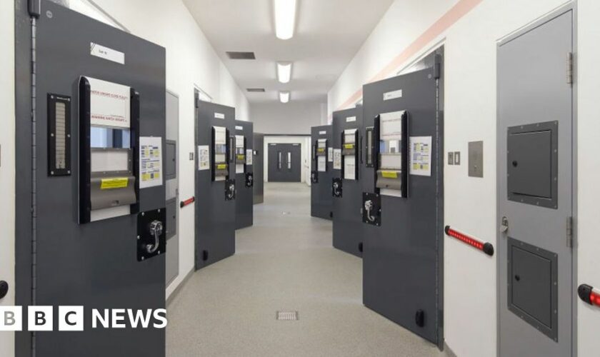 Corridor with custody cell doors - Keynsham Custody Suite