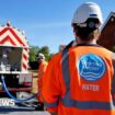 A worker from Thames Water delivering a temporary water supply from a tanker to the village of Northend in Oxfordshire on 10 August 2022