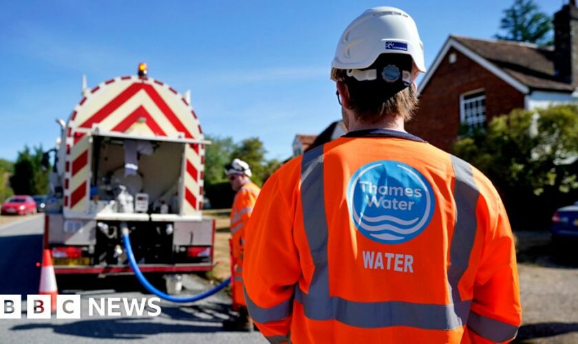 A worker from Thames Water delivering a temporary water supply from a tanker to the village of Northend in Oxfordshire on 10 August 2022