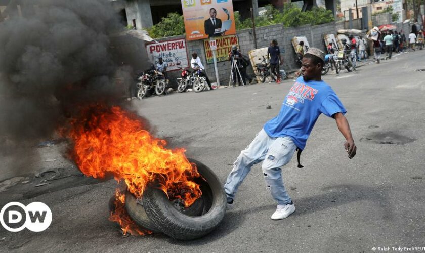 A burned car is seen outside the National Penitentiary in downtown Port-au-Prince, Haiti