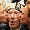 D-Day veteran Alec Penstone, 98, who served with the Royal Navy, receives a kiss from the D-Day Darlings. Pic: PA