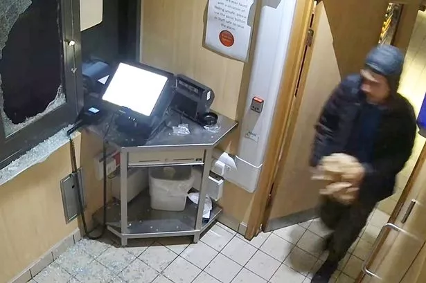 Bizarre moment hungry burglar is caught on CCTV stealing food from McDonald's
