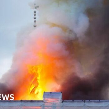 The spire collapses on the old stock exchange building in Copenhagen