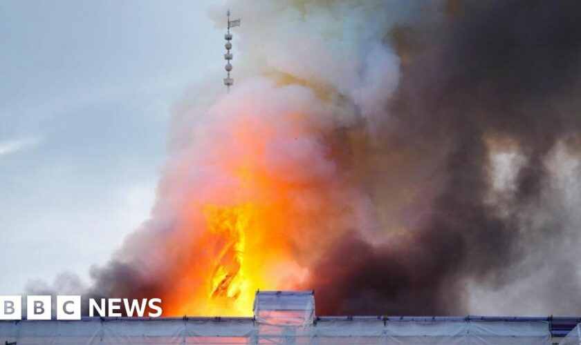 The spire collapses on the old stock exchange building in Copenhagen