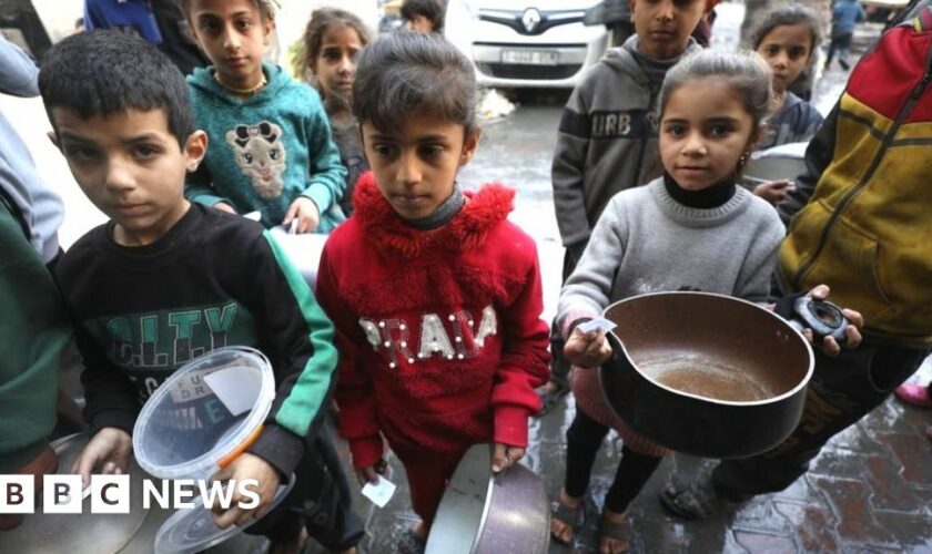 Children in Gaza wait with empty pots at a food distribution point