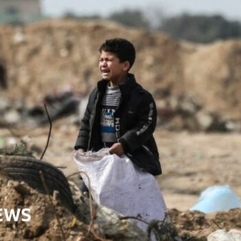 A Palestinian boy cries as he stands amid debris in the Maghazi in central Gaza