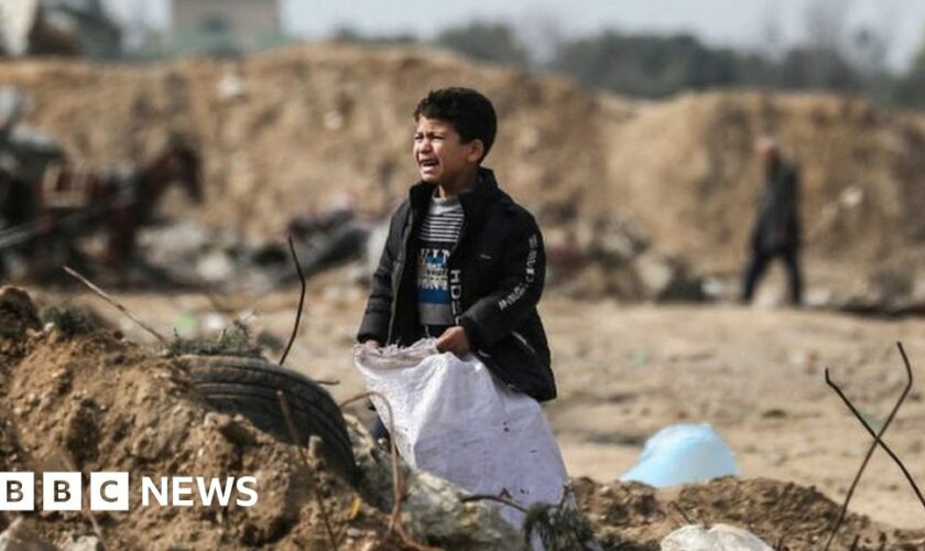 A Palestinian boy cries as he stands amid debris in the Maghazi in central Gaza