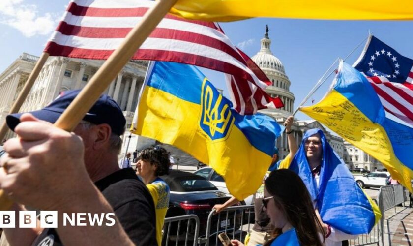 Supporters of Ukraine wave US and Ukrainian flags outside the US Capitol after the House approved foreign aid packages to Ukraine