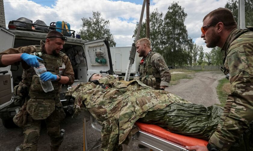 Military paramedics treat a wounded Ukrainian soldier in Kharkiv region. Pic: Reuters