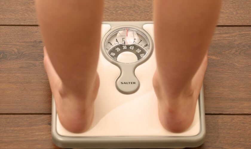 A file picture, posed by a model, showing a person standing on scales. Picture tags, weight loss, diet, health