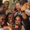 Meghan poses for sweet selfie with schoolchildren in Nigeria - while Harry pulls a funny face - after Duchess said 'I see myself in all of you' - as couple kick off three-day 'royal tour'