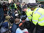 Moment police form ring of steel around coach taking asylum seekers to Bibby Stockholm barge as clashes turn violent: Gen Z protesters descend on Peckham chanting 'migrants welcome' and try to block path of bus after answering call on social media