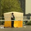An office stands next to a white tent within a police cordon