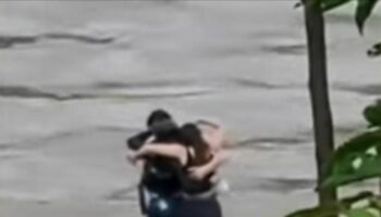 Friends seen in 'final embrace' before being swept away by flood
