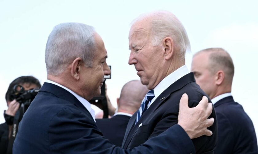 Le Premier ministre israélien Benjamin Netanyahu (g) salue le président américain Joe Biden à son arrivée à l'aéroport Ben Gourion de Tel Aviv, le 18 octobre 2023