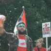 Anti-Israel agitator in Hamas headband holds up bloodied Biden face mask steps from White House