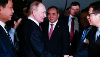 Vladimir Putin is greeted by Vietnamese officials on his arrival in Hanoi Pic: AP
