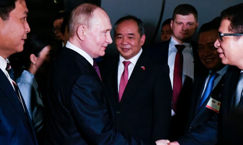 Vladimir Putin is greeted by Vietnamese officials on his arrival in Hanoi Pic: AP