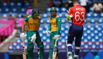 South Africa's Reeza Hendricks, left, and batting partner Quinton de Kock stand between the wickets during the ICC Men's T20 World Cup cricket match between England and South Africa at Darren Sammy National Cricket Stadium in Gros Islet, Saint Lucia, Friday, June 21, 2024. (AP Photo/Ramon Espinosa)