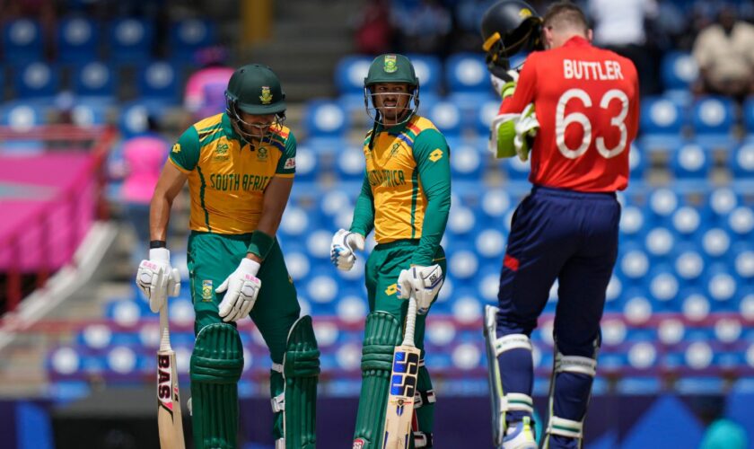 South Africa's Reeza Hendricks, left, and batting partner Quinton de Kock stand between the wickets during the ICC Men's T20 World Cup cricket match between England and South Africa at Darren Sammy National Cricket Stadium in Gros Islet, Saint Lucia, Friday, June 21, 2024. (AP Photo/Ramon Espinosa)