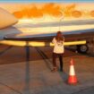 An image from a handout video of Just Stop Oil protesters spraying orange paint over private jets at Stansted Airport. Pic: PA