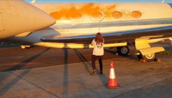 An image from a handout video of Just Stop Oil protesters spraying orange paint over private jets at Stansted Airport. Pic: PA