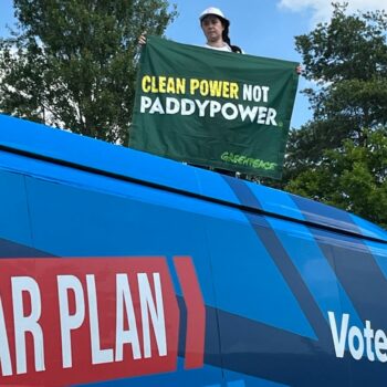 Amy Rugg-Easey on top of the Conservative election campaign bus in Nottinghamshire on Wednesday. Pic: PA