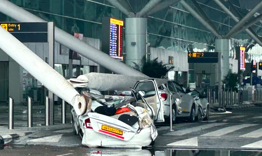 Parked vehicles are damaged by the collapse of a departure terminal canopy at New Delhi's Indira Gandhi International Airport following heavy pre-monsoon rains in New Delhi, India, Friday, June 28, 2024. (AP Photo)