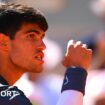 Carlos Alcaraz clenches his fist and his teeth in celebration at the French Open