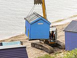 Beach huts worth £750,000 are demolished after being condemned when battered by winter storms - as owners who are now £25,000 out of pocket are billed an extra £300 each to pay for the operation