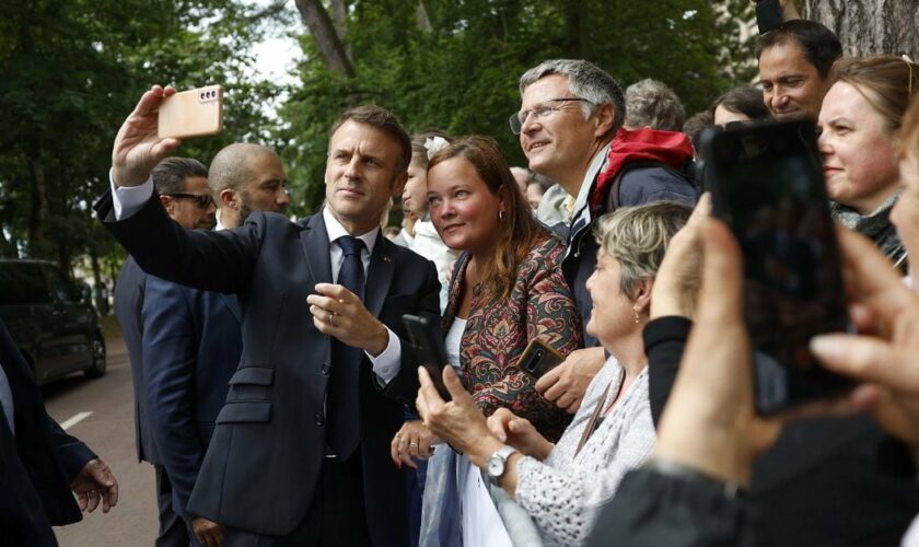 Le président Emmanuel Macron prend un selfie avec des sympathisants après avoir voté au second tour des élections législatives, le 7 juillet 2024 au Touquet