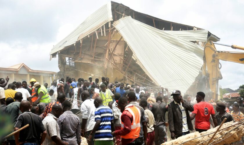 People and rescuers gather at the scene of a collapsed two-storey building in Jos, Nigeria. Pic: AP