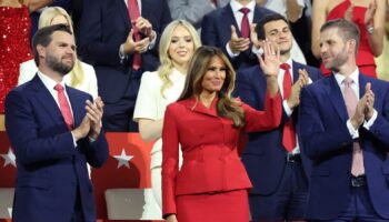 Former first lady Melania Trump waves as she is flanked by vice presidential nominee Senator J.D. Vance (R-OH) and Donald Trump Jr., as Republican presidential nominee and former U.S. President Donald Trump speaks on Day 4 of the Republican National Convention (RNC), at the Fiserv Forum in Milwaukee, Wisconsin, U.S., July 18, 2024. REUTERS/Andrew Kelly