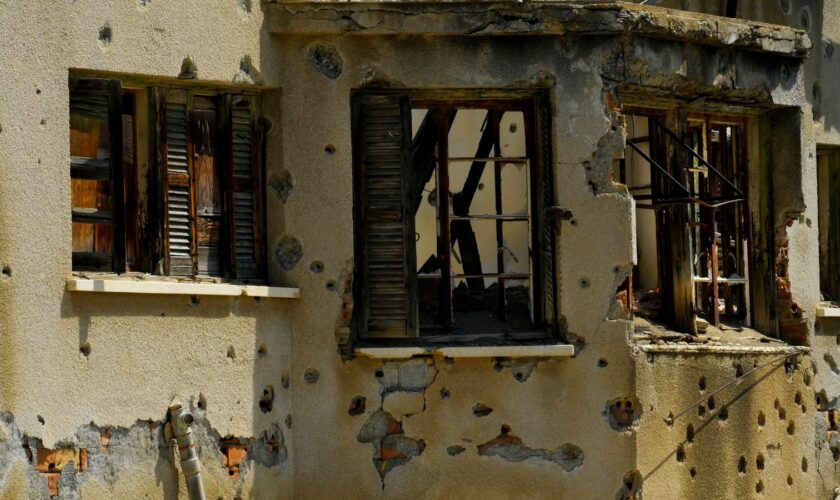 The holes from bullets are seen on an abandoned building inside the war-torn U.N. buffer zone in divided capital, Nicosia, Cyprus, Thursday, June 6, 2024. Fifty years after war cleaved Cyprus along ethnic lines, tensions are rekindling along the 180-kilometer-long buffer zone separating Turkish Cypriots from Greek Cypriots. It's another potential source of instability in an already tumultuous region. (AP Photo/Petros Karadjias)