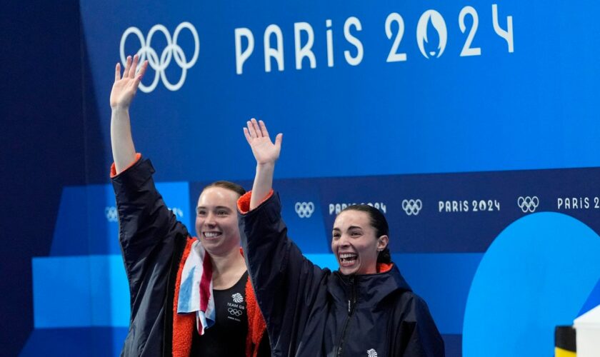 Britain's Yasmin Harper and Scarlett Mew Jensen celebrates after winning the bronze medal in the women's synchronised 3m springboard diving final at the 2024 Summer Olympics, Saturday, July 27, 2024, in Saint-Denis, France. (AP Photo/Lee Jin-man)