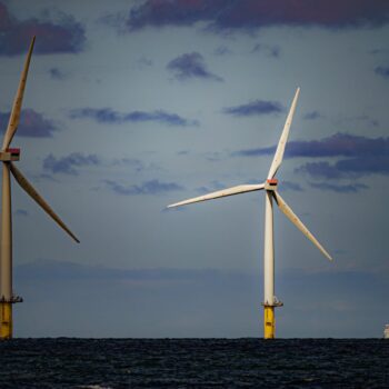 File photo dated 26/07/2022 of a ship passing wind turbines at RWE's Gwynt y Mor, the world's 2nd largest offshore wind farm located eight miles offshore in Liverpool Bay, off the coast of North Wales. The Crown Estate is to pay even more money to the Treasury after benefiting from a massive licensing round for offshore wind power last year. The company, which owns the seabed around the UK, said it made £442.6 million in net revenue profit in the year to the end of March, money that will go to h