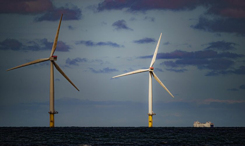 File photo dated 26/07/2022 of a ship passing wind turbines at RWE's Gwynt y Mor, the world's 2nd largest offshore wind farm located eight miles offshore in Liverpool Bay, off the coast of North Wales. The Crown Estate is to pay even more money to the Treasury after benefiting from a massive licensing round for offshore wind power last year. The company, which owns the seabed around the UK, said it made £442.6 million in net revenue profit in the year to the end of March, money that will go to h