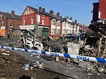 Leeds in rubble: Clear-up begins after night of shame which saw a patrol car tipped over and a bus torched - as questions grow over how the city was left to burn for hours after riot police were driven out by thugs
